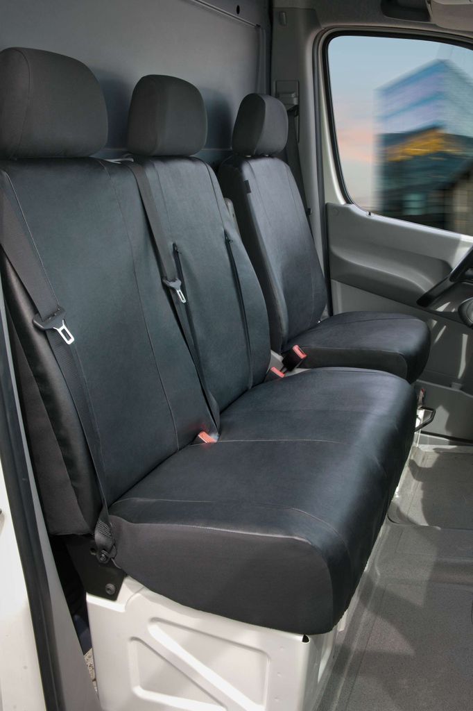 Interior view of a van showing black seat covers on the front seats.