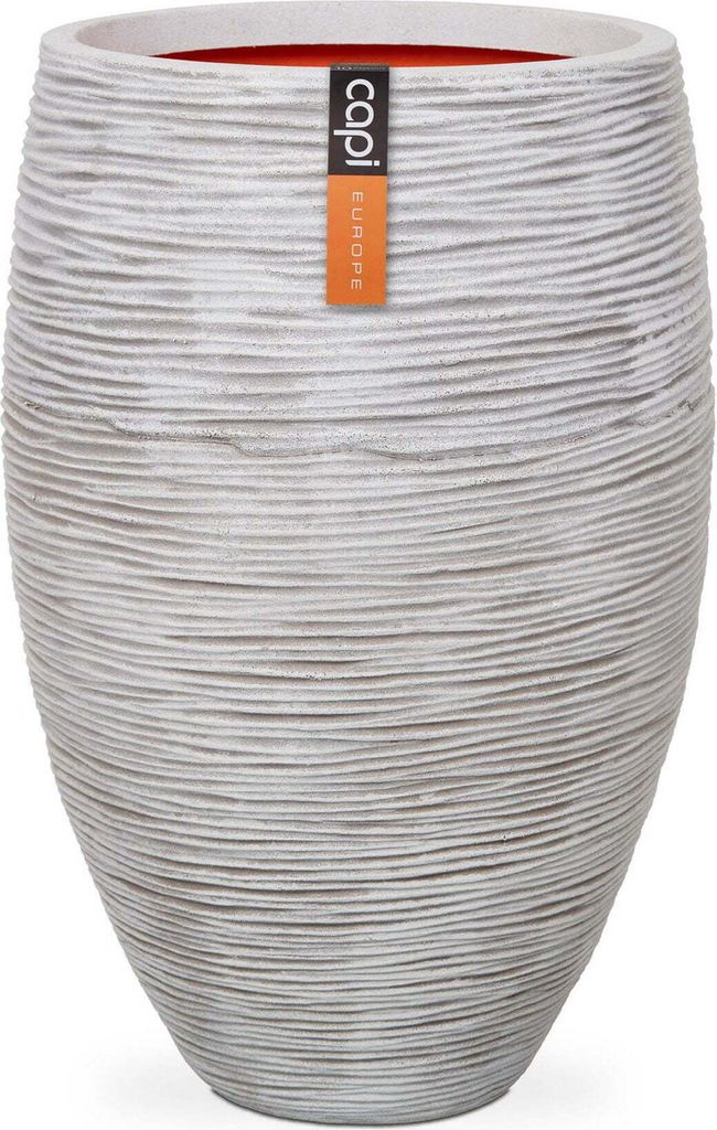 A tall, textured planter pot with a label attached.
