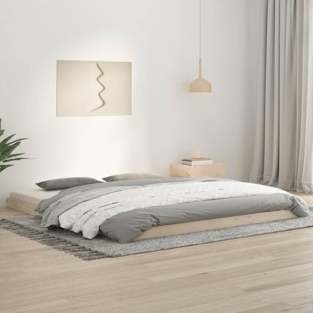 A minimalist bedroom scene with a wooden bed frame and bedding.