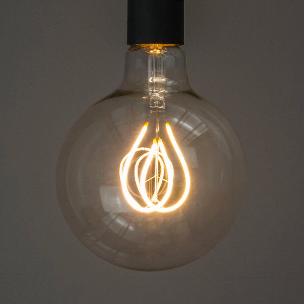 A close-up shot of a vintage-style LED light bulb with a decorative filament.