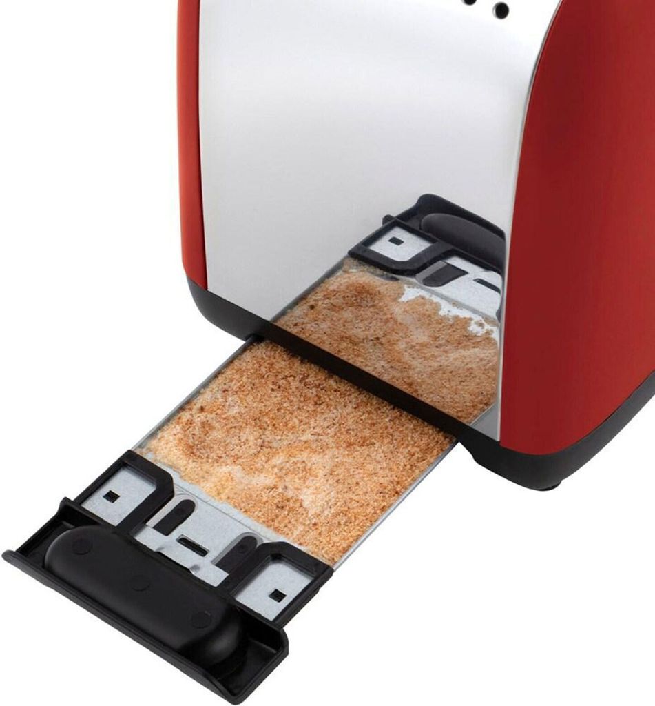 A close-up view of a red toaster with its crumb tray extended, showing toasted bread crumbs inside.