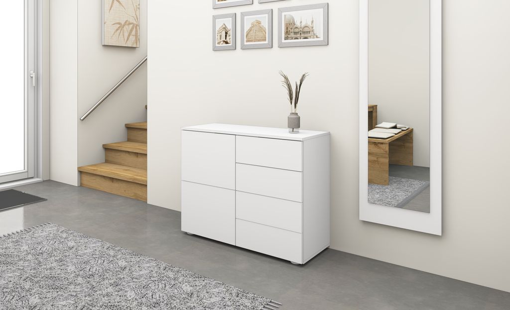 A white dresser is shown in a hallway next to a staircase and a mirror.