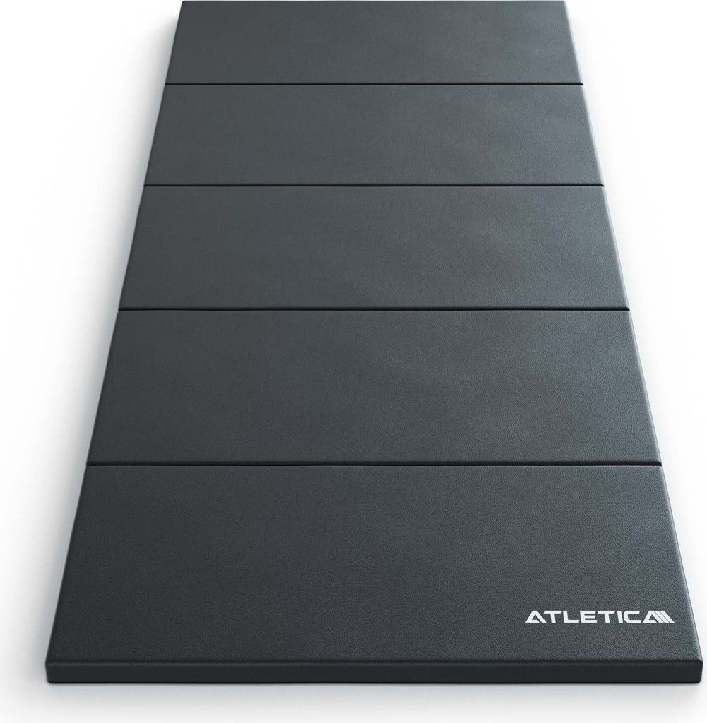 A dark gray folding mat on a white background.