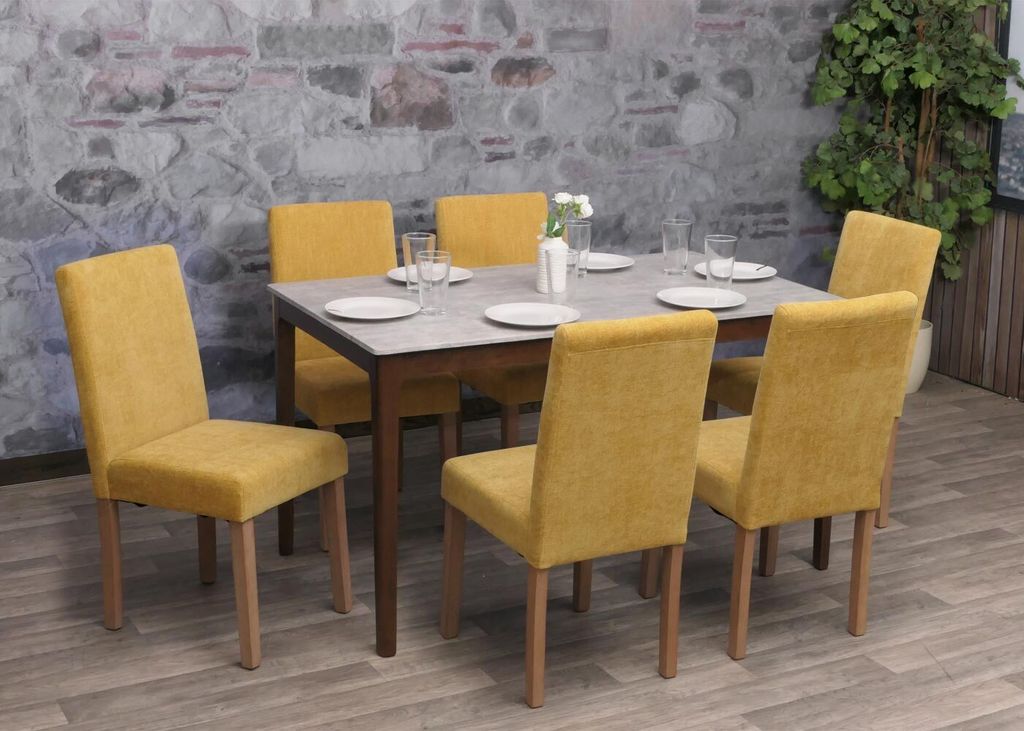 A dining room set with six yellow chairs around a table.