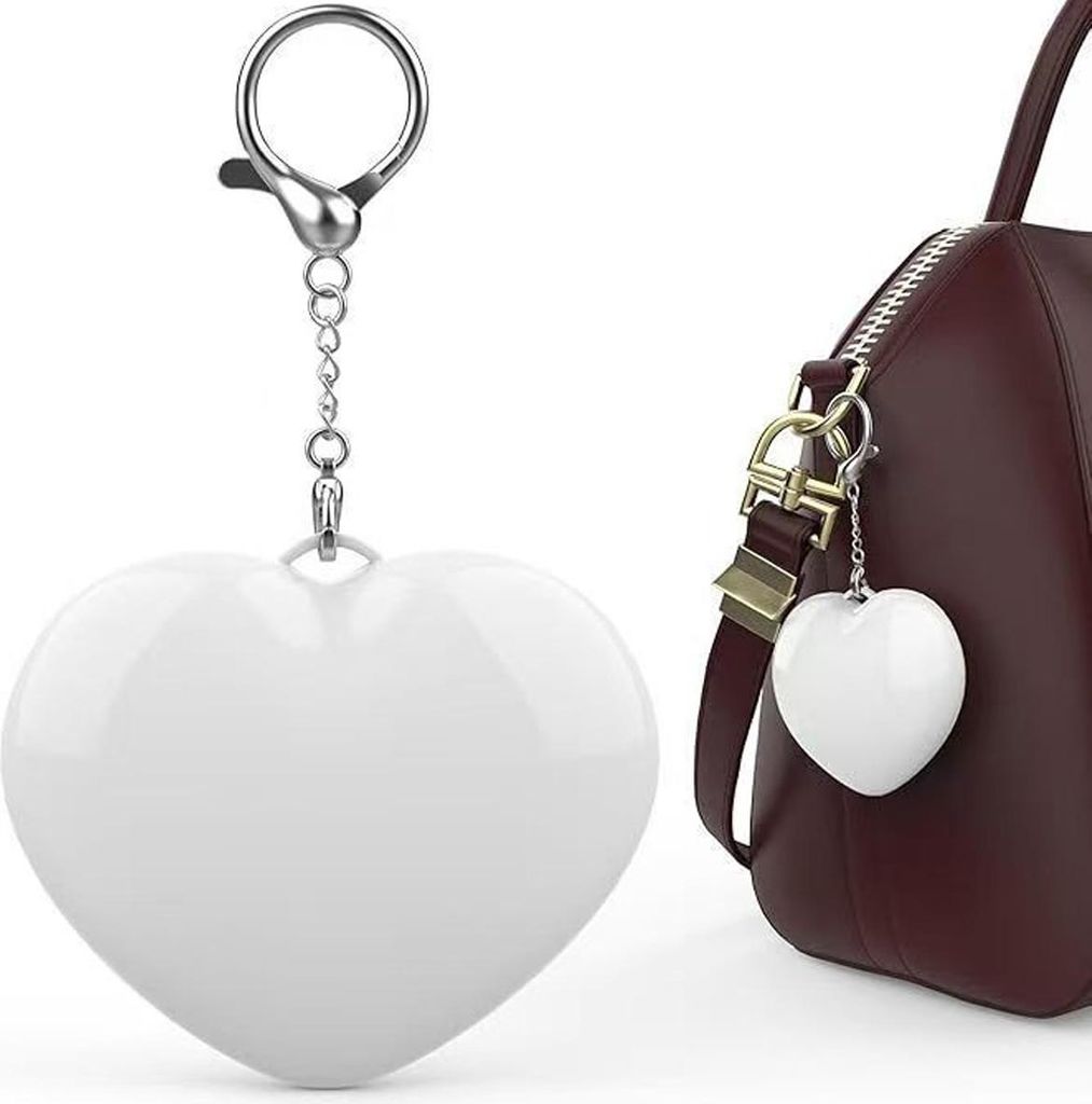 A white heart-shaped keychain is shown on the left, and a similar keychain is attached to a brown handbag on the right.
