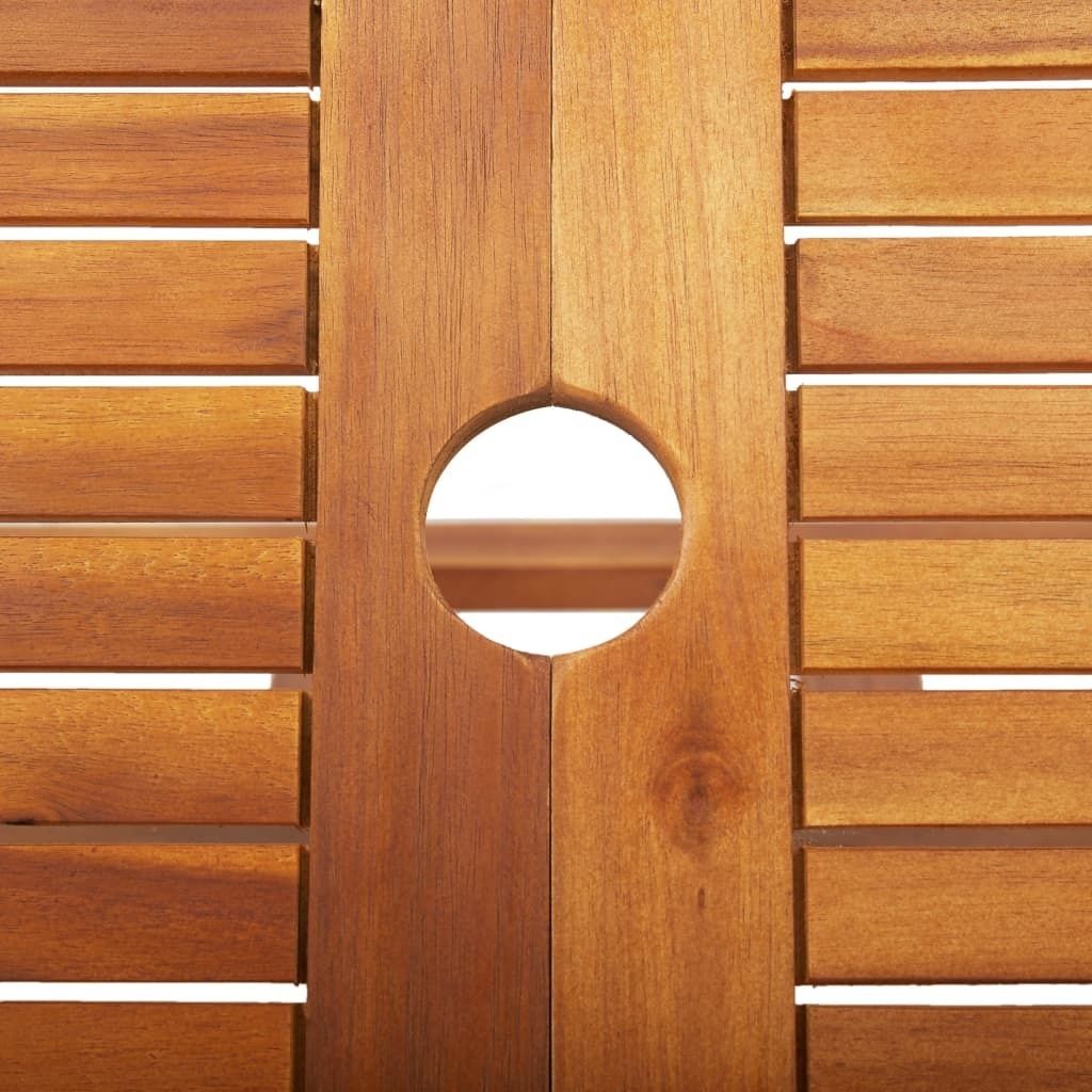 A close-up view of a wooden table with a circular cutout in the center.