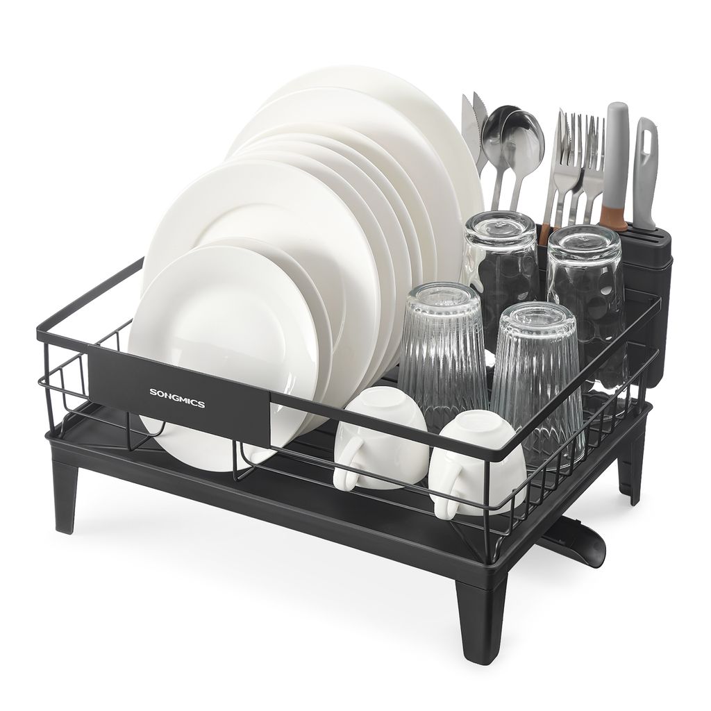 A black dish drying rack filled with white plates, glasses, and cutlery, set against a white background.