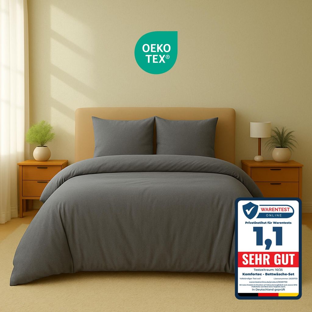 A bed with gray bedding in a room setting.