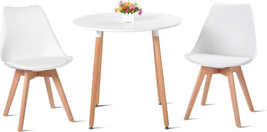 A white round table with two white chairs and a small vase of flowers on top of the table.