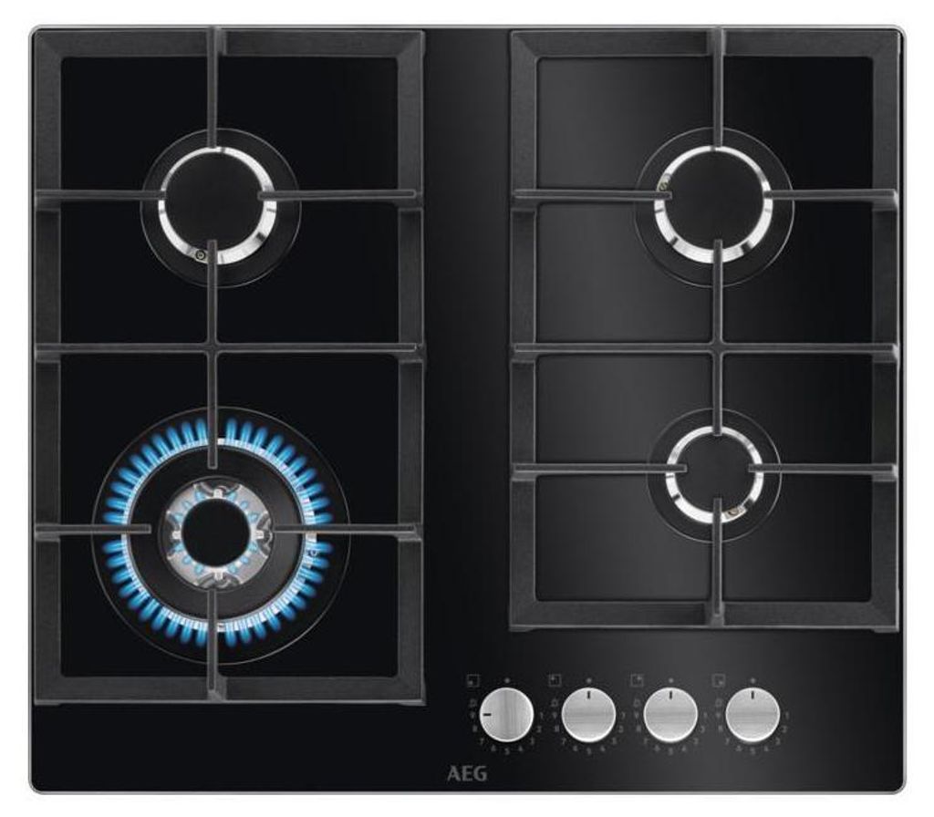 A top-down view of a black gas stovetop with four burners. One burner is lit with blue flames.