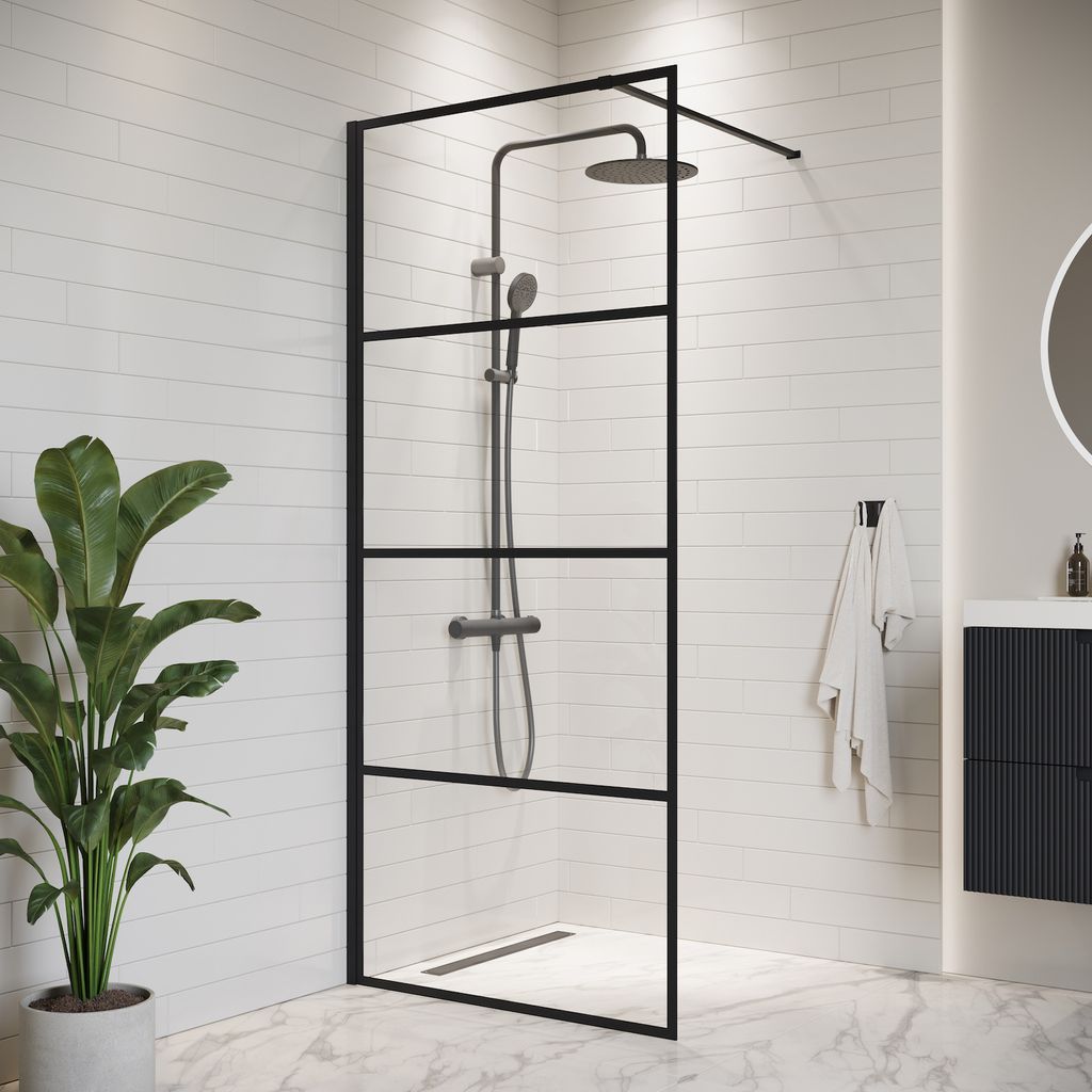 A modern bathroom with a walk-in shower, a plant, and a vanity.