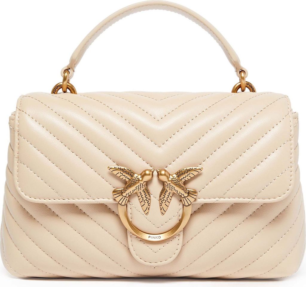 A studio shot of a beige handbag.
