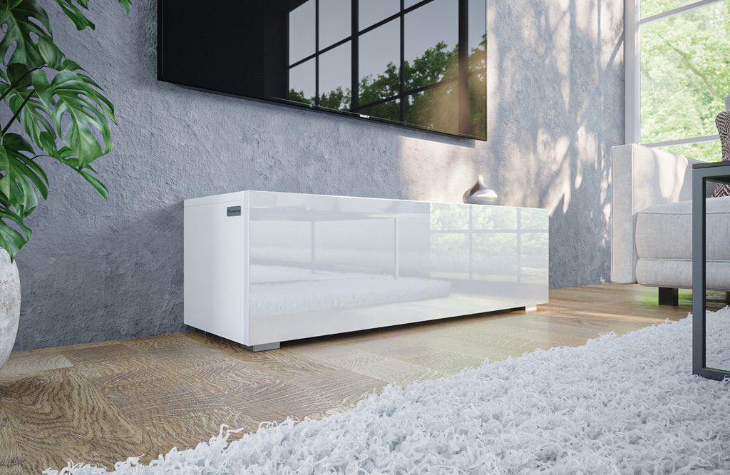 A modern, glossy white TV stand with a wall-mounted television above it in a living room setting.