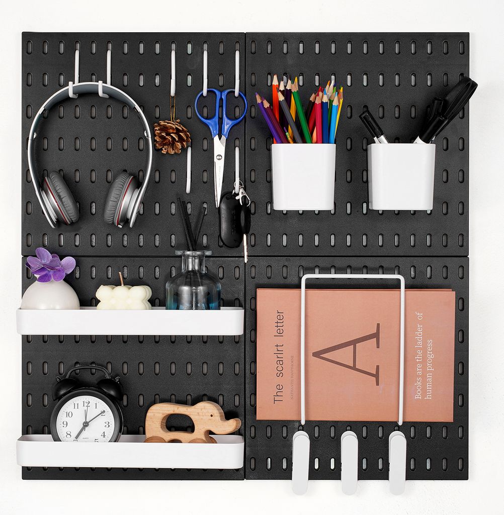 A pegboard wall organizer with various items attached.