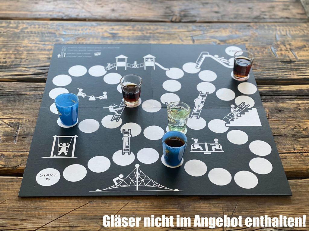 A board game with shot glasses filled with drinks placed on it, set on a wooden table.