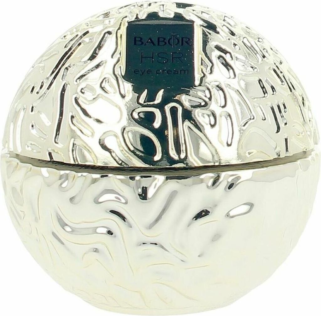 A silver, spherical jar of eye cream with a textured surface and a black label.