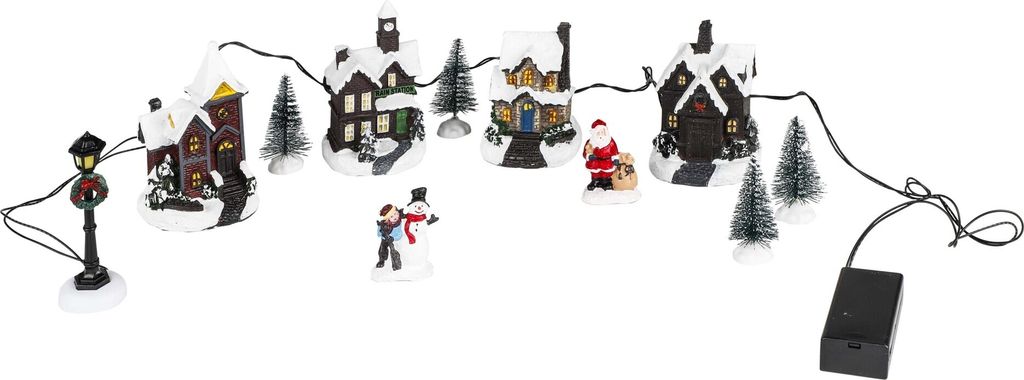 A string of miniature Christmas village houses and figures, illuminated by LED lights, set against a white background.