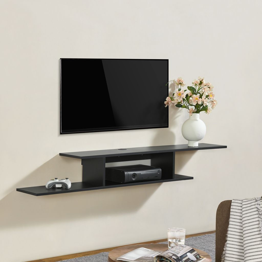 A black wall-mounted TV shelf with a TV, a game controller, and a media box.