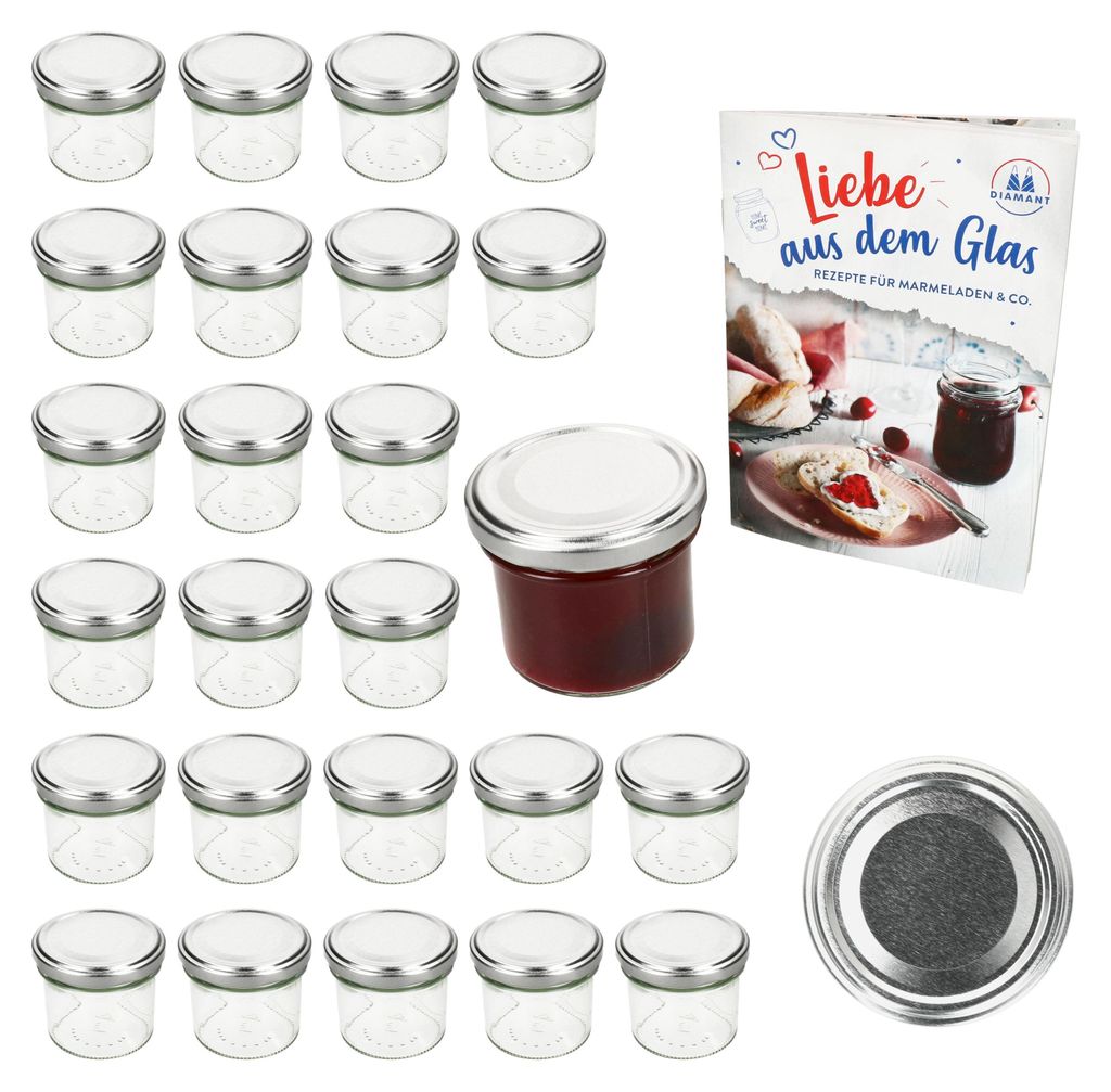 A set of small glass jars with silver lids, a single jar filled with red jam, and a recipe book, all arranged on a white background.