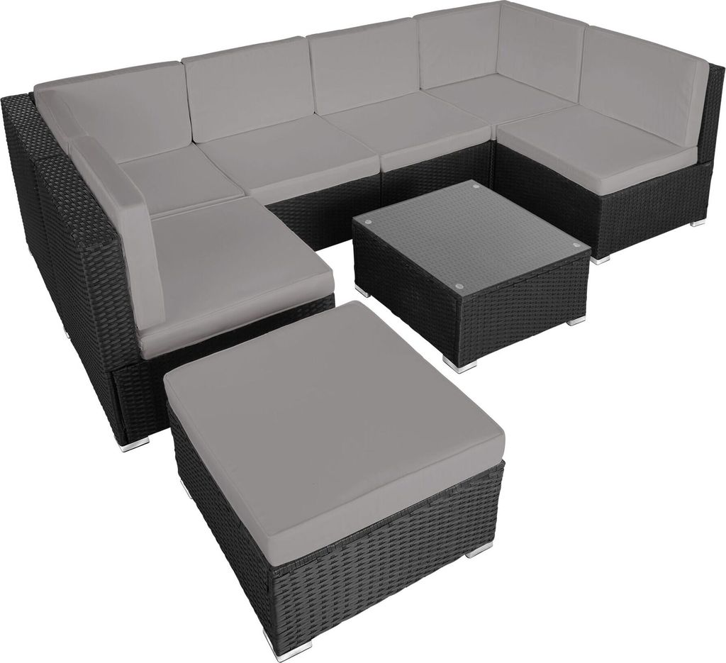 A sectional outdoor furniture set with cushions and a coffee table, displayed on a white background.