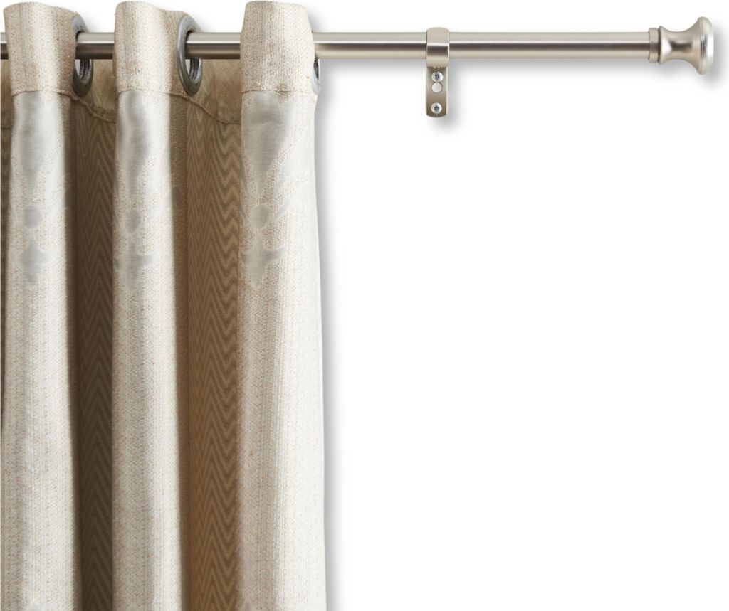 A close-up of a curtain rod with a beige curtain hanging from it.