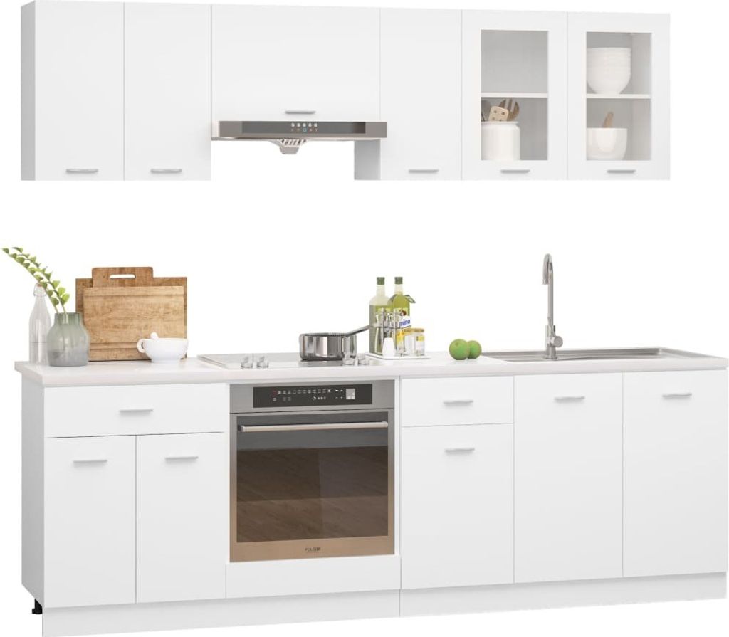 A white kitchen unit with cabinets, an oven, a sink, and a faucet.