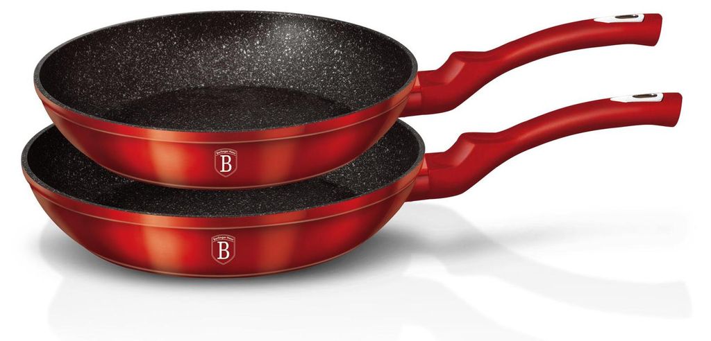 Two red frying pans stacked on a white background.