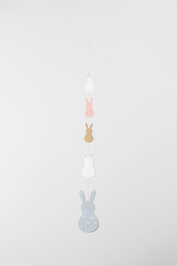 A garland of bunny-shaped ornaments hanging against a plain background.