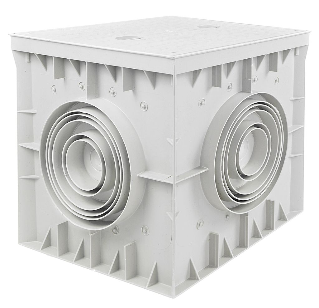 A white plastic inspection chamber with multiple pipe inlets.