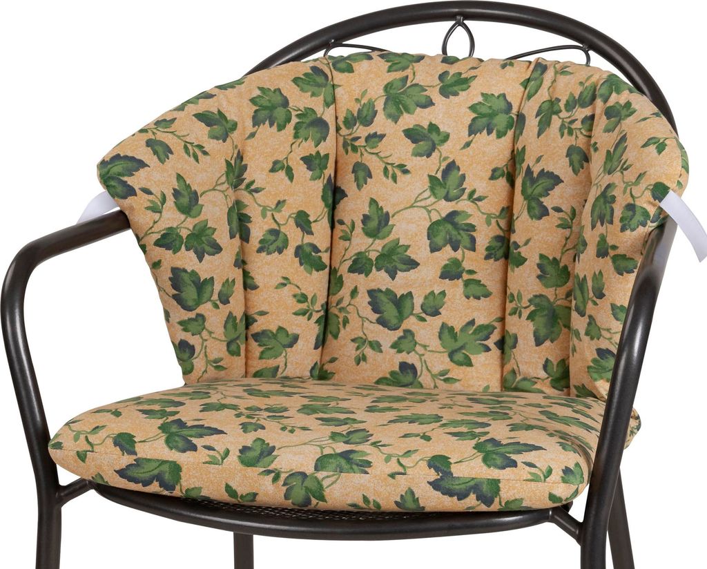 A close-up shot of a chair cushion with a leaf pattern.