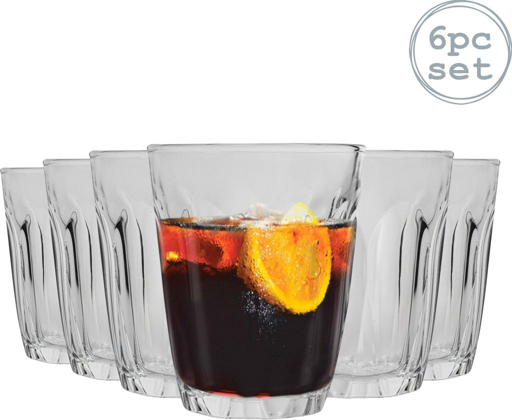 A set of six clear glasses, with one glass filled with a dark beverage and a slice of orange.