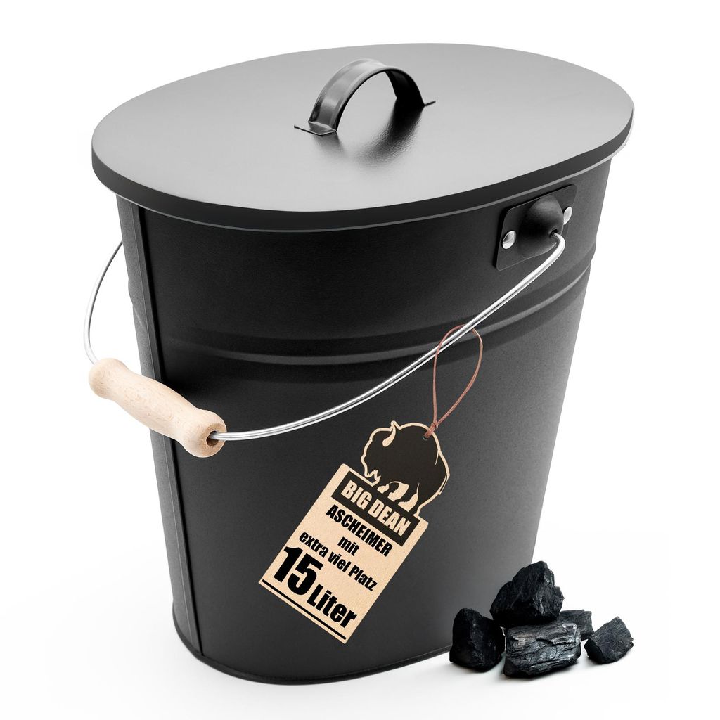 A black oval ash bucket with a lid and handle, placed on a white background with a few pieces of coal next to it.
