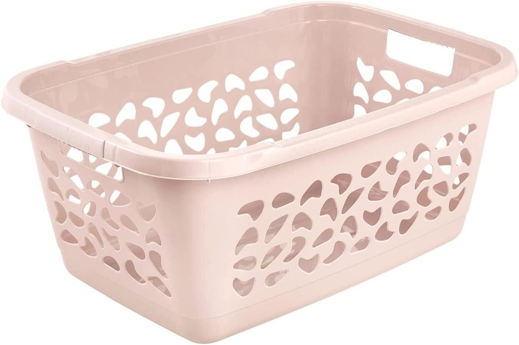 A light pink laundry basket with a decorative pattern of cutouts on its sides, shown from a slightly elevated side angle against a white background.