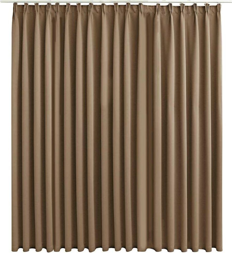 A full-frame shot of a taupe-colored curtain hanging from a rod.