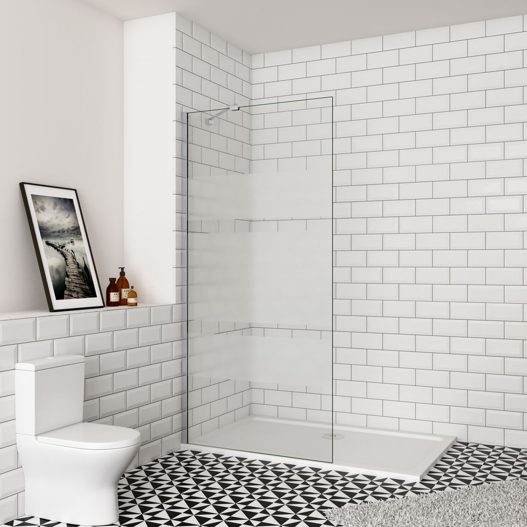 A modern bathroom with a toilet, a walk-in shower, and tiled walls and floor.