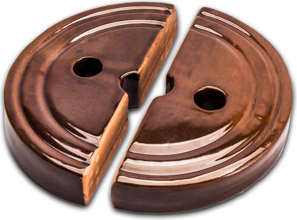 Two halves of a brown ceramic weight for a fermentation crock.