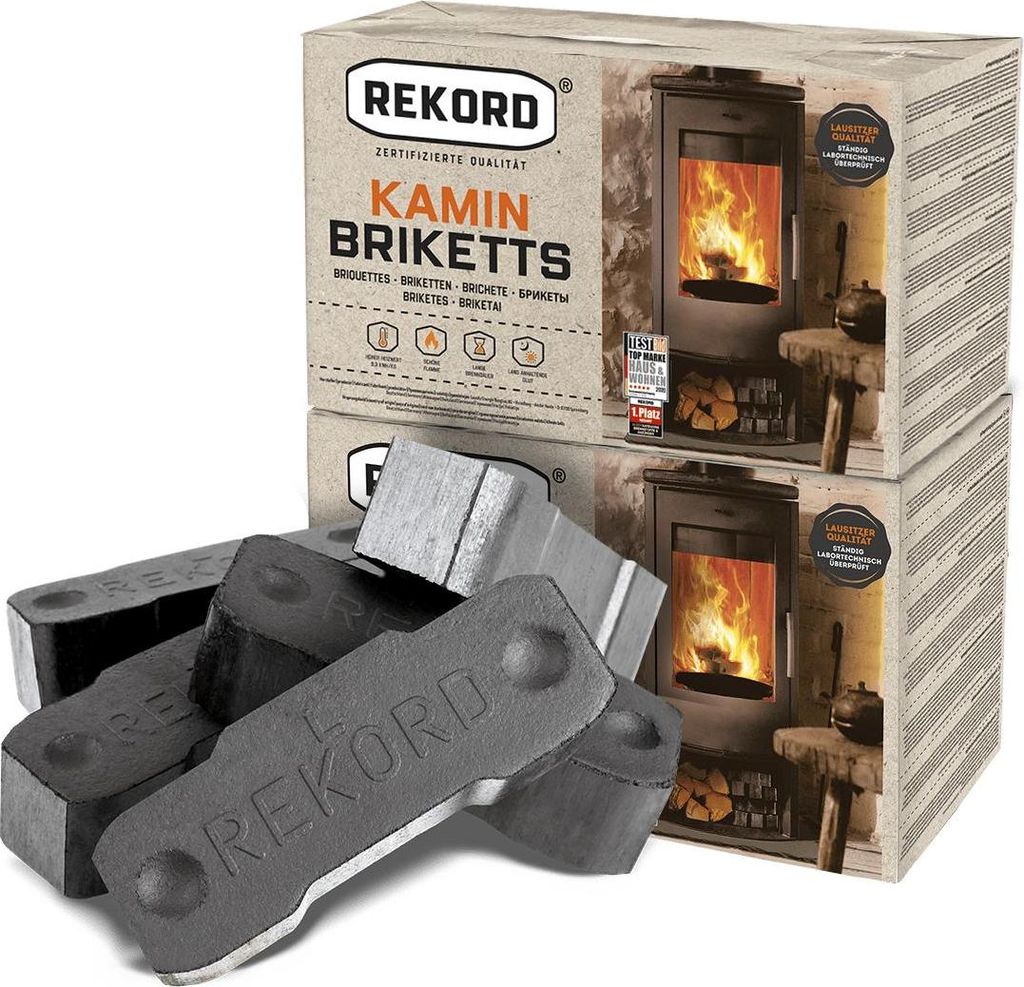 A product shot of Rekord Kamin Briketts with two boxes stacked and several briquettes in the foreground.