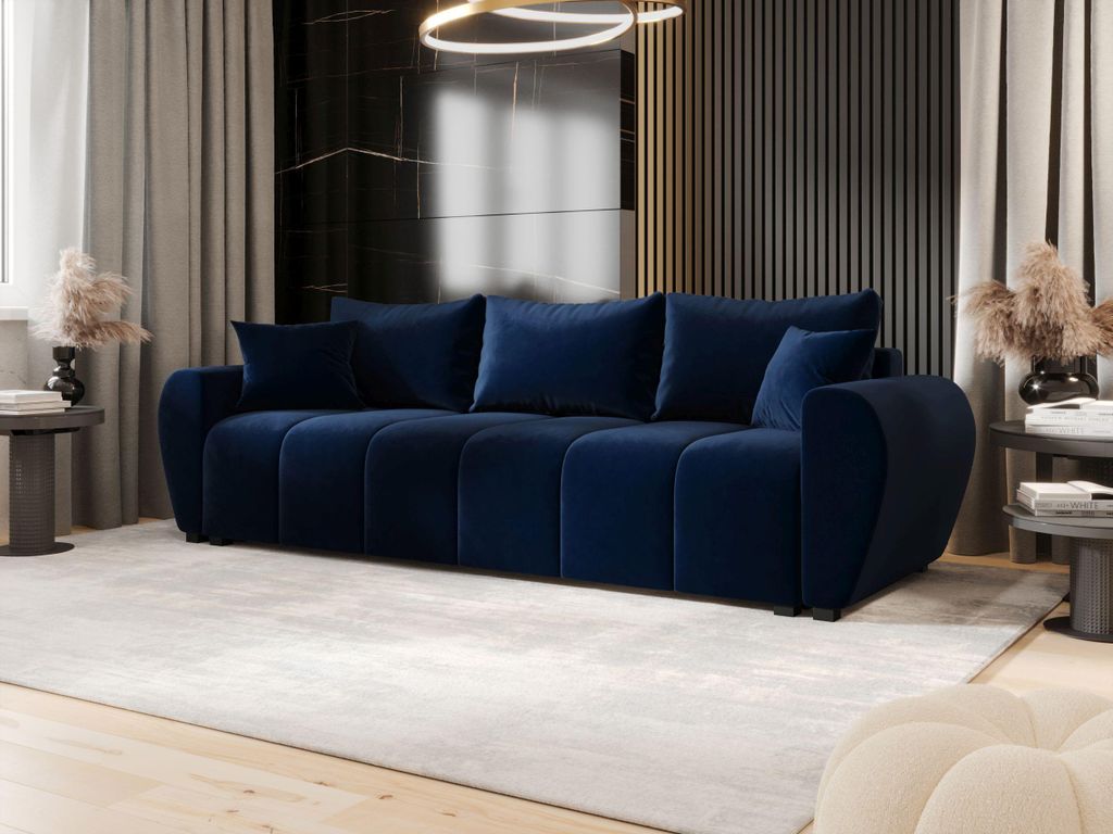 A modern living room with a dark blue velvet sofa as the main focal point.