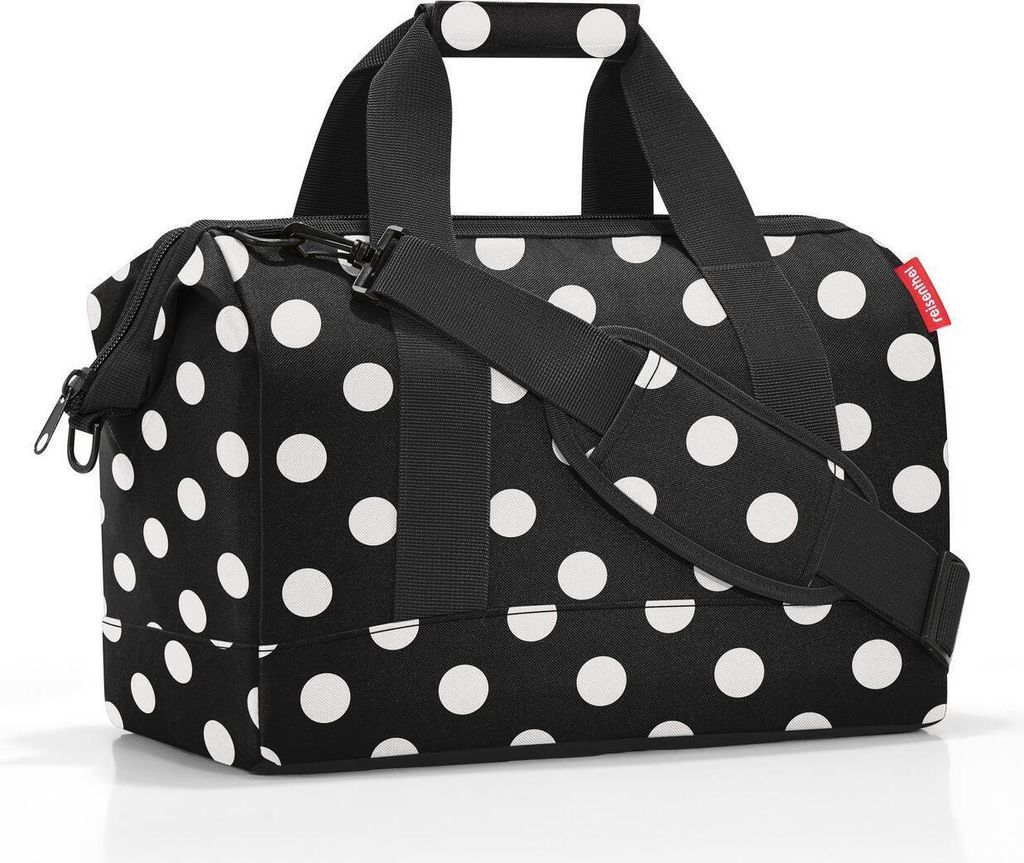 A black and white polka dot duffel bag.