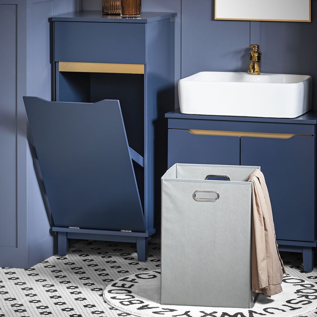 A bathroom scene with a blue cabinet, sink, and laundry basket.