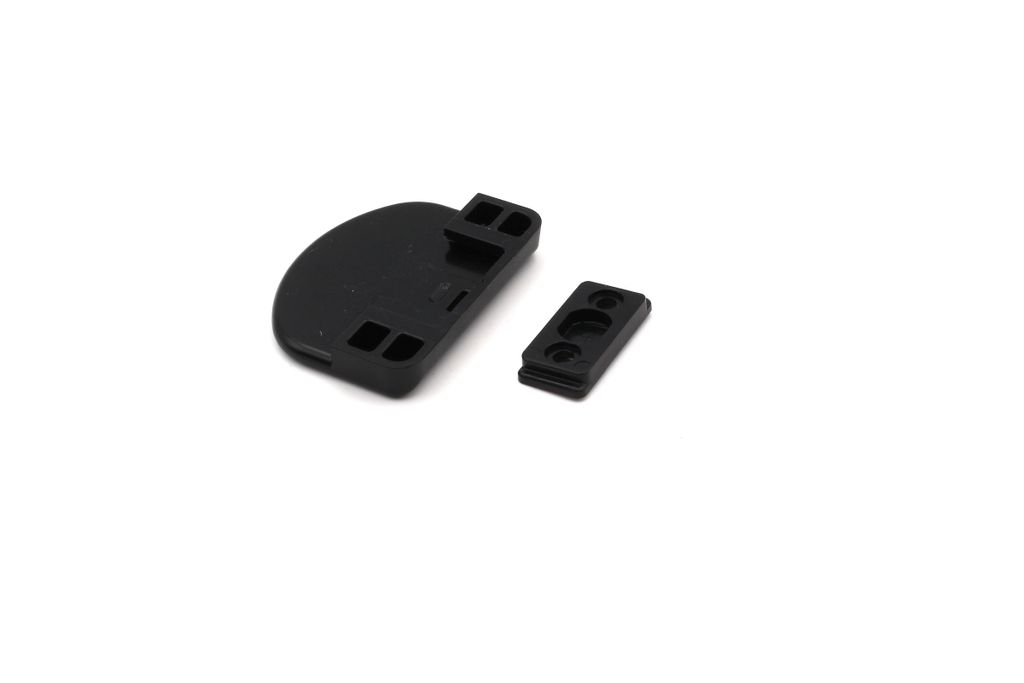 Two black plastic components for a window or door handle are shown on a white background.