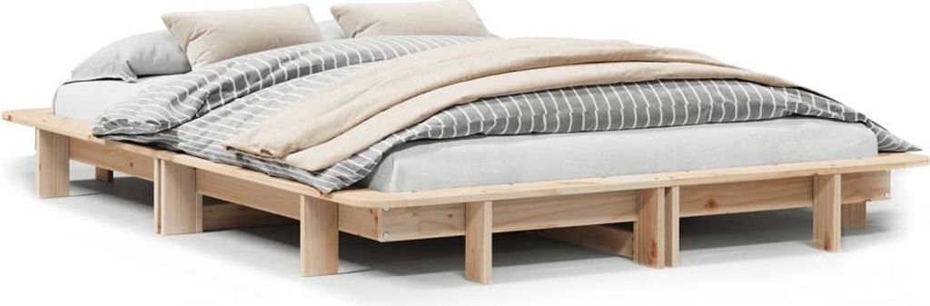 A wooden bed frame with bedding and pillows, shown from a slightly elevated side angle against a white background.