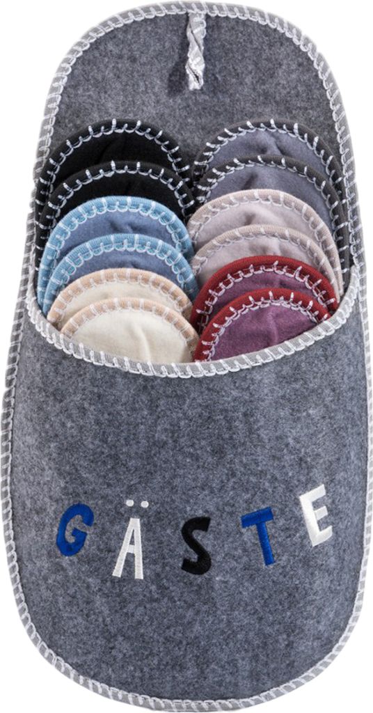 A grey felt slipper-shaped organizer filled with colorful guest slippers, with the word "GÄSTE" embroidered on the front.