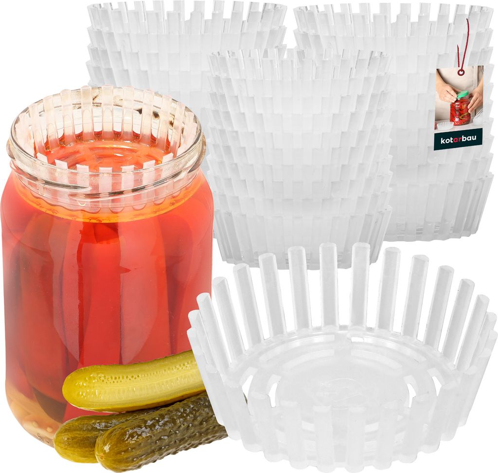 A glass jar filled with red pickled items and two pickles in front of it, surrounded by stacks of white plastic fermentation weights.