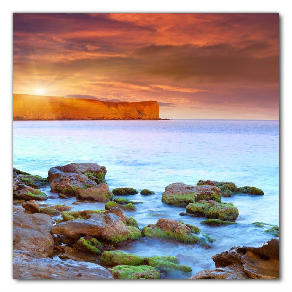 Wallario selbstklebende Möbelfolie/ Tischdecke für Innen und Außen, Größe: 50 x 50 cm - Sonnenaufgang am Meer mit Landzunge und Felsen im Wasser
