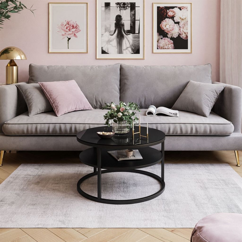 A living room scene with a sofa, coffee table, and artwork.