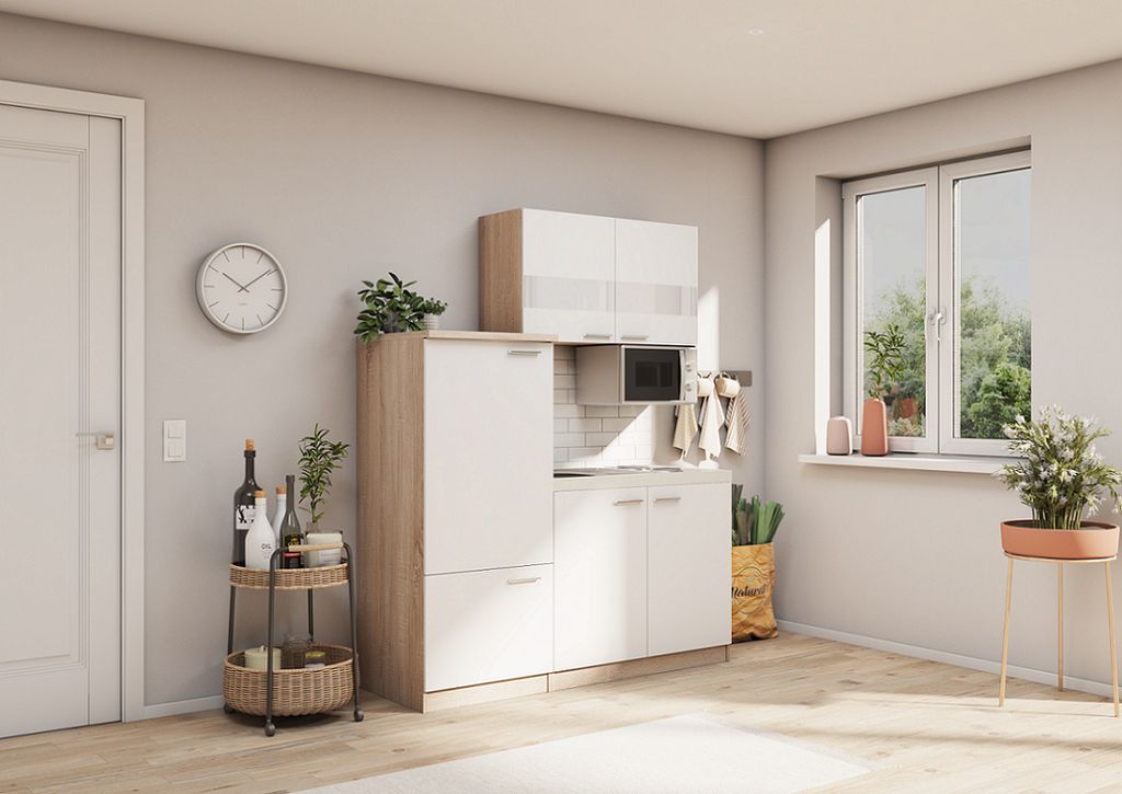 A small kitchen setup in a room with a window.