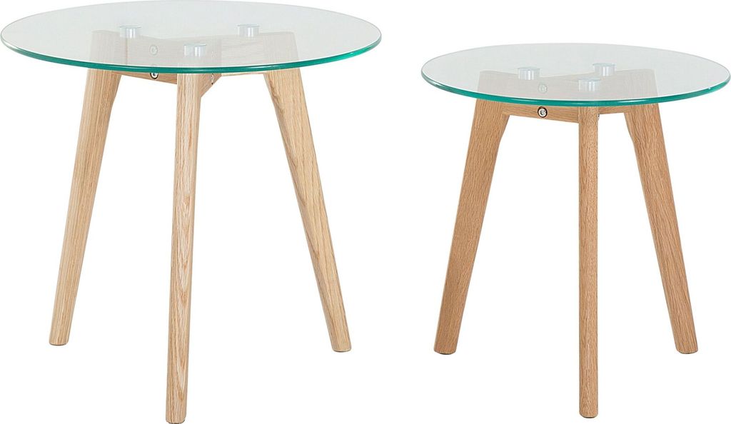 Two round tables with glass tops and wooden legs are shown against a white background.