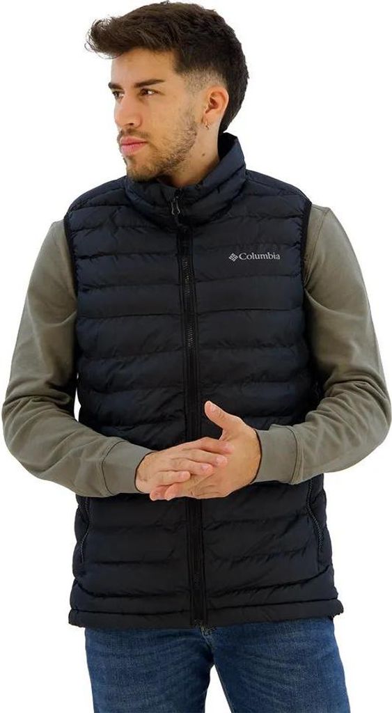 A man wearing a black vest over a gray long-sleeved shirt.