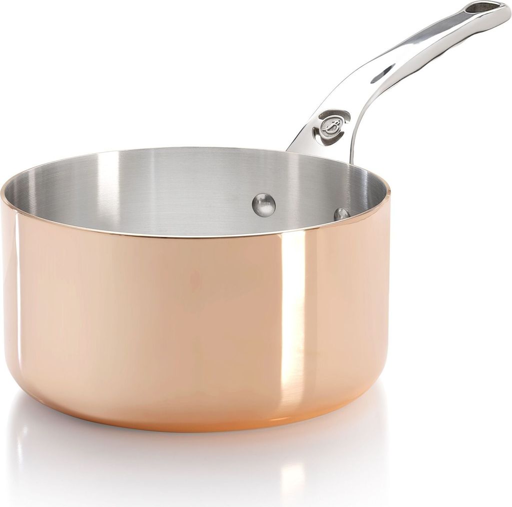 A close-up studio shot of a copper saucepan with a silver handle, set against a white background.